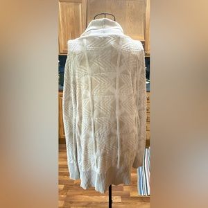 Lightweight but warm sweater, tan/beige in color. No rips, tears or stains.